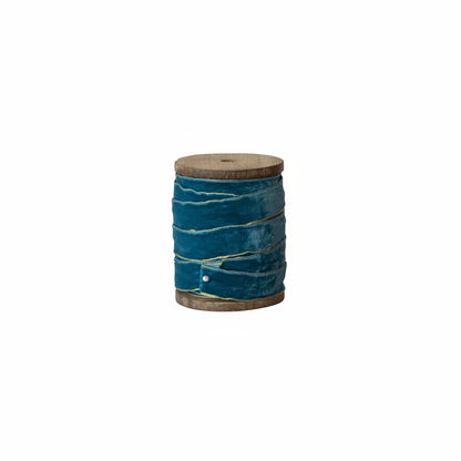 blue ribbon on wooden spool