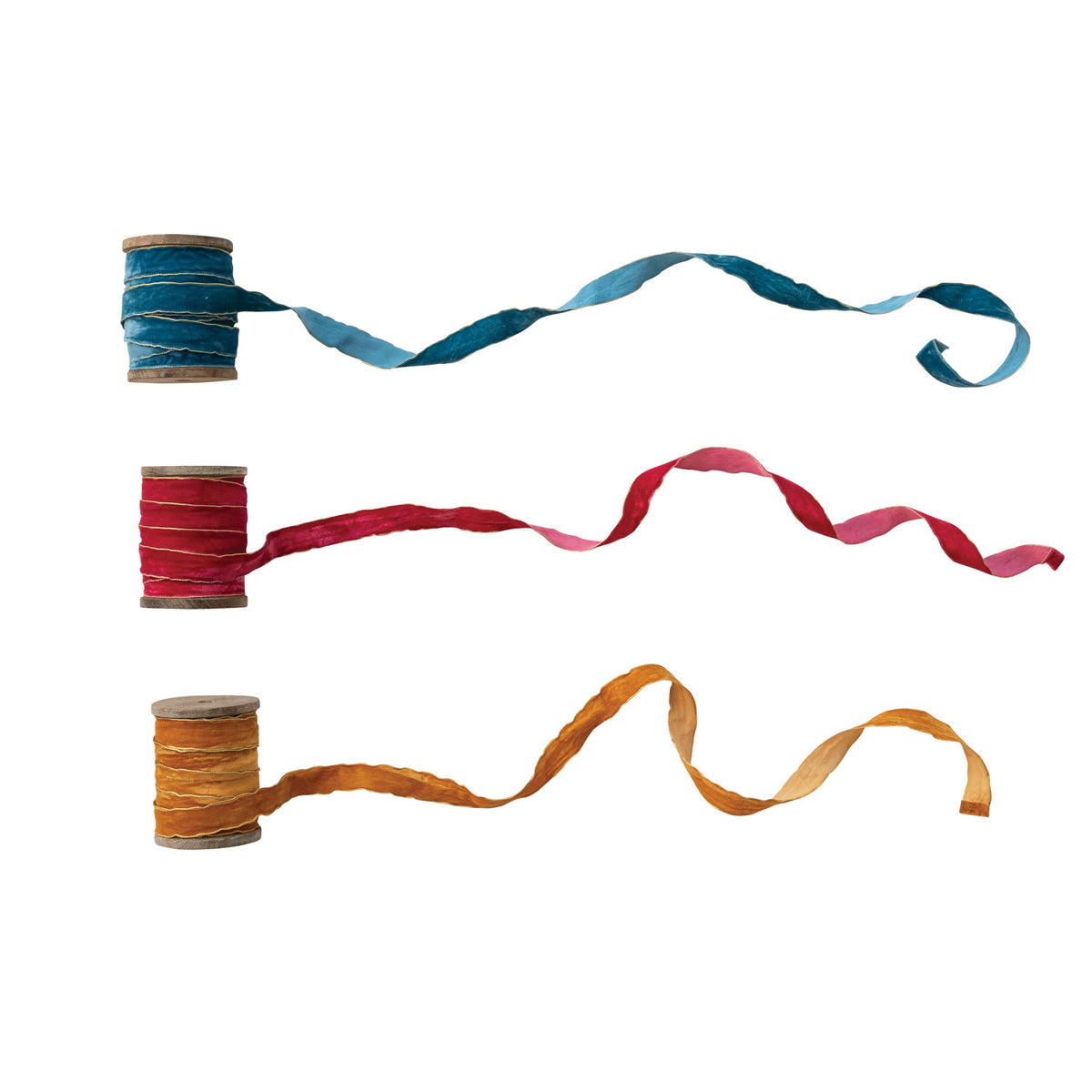 3 velvet ribbons unspooling on a white background