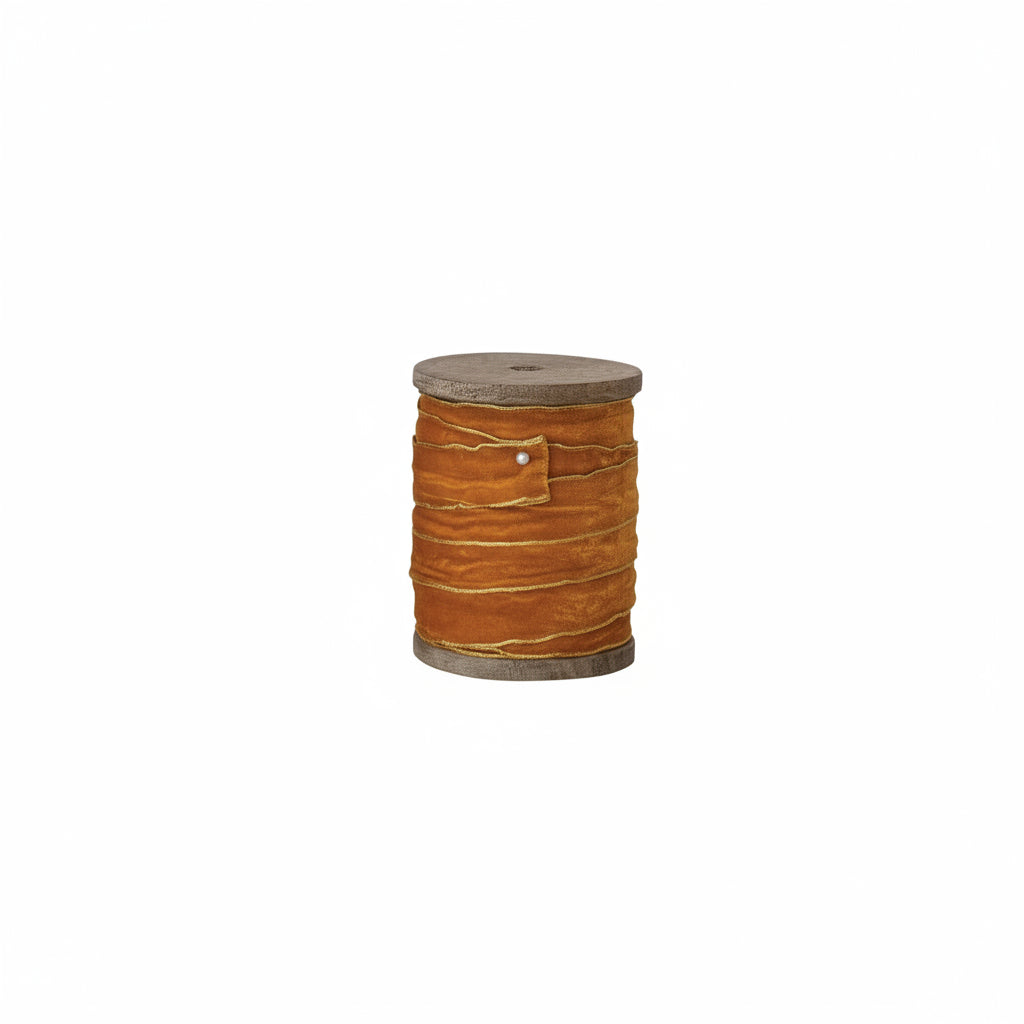 gold ribbon on wooden spool