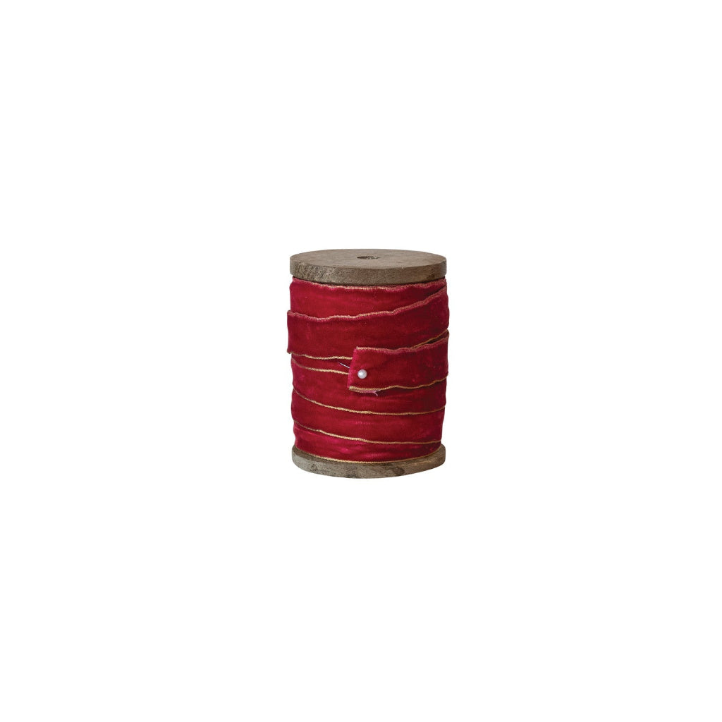 red ribbon on wooden spool