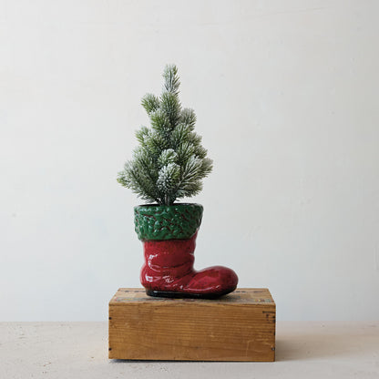 boot container on a block of wood with a christmas tree in it