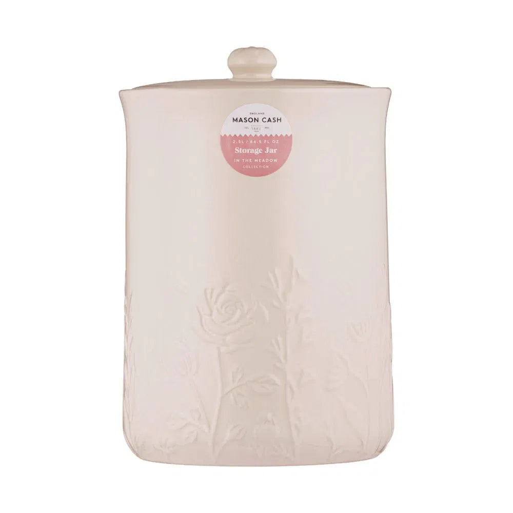 White ceramic storage jar with lid and floral design on a white background