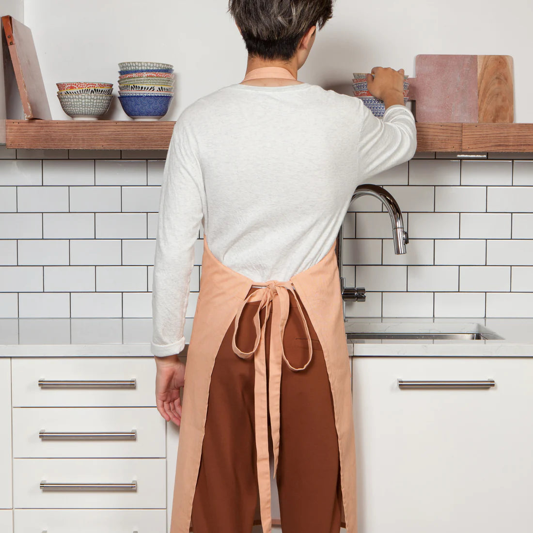 back view of a person wearing nectar apron in a kitchen.