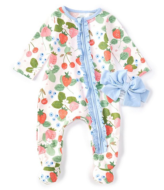 footed infant sleeper with pink background, berries and flower pattern, and blue ruffle along front zipper. blue headband bow is next to sleeper.