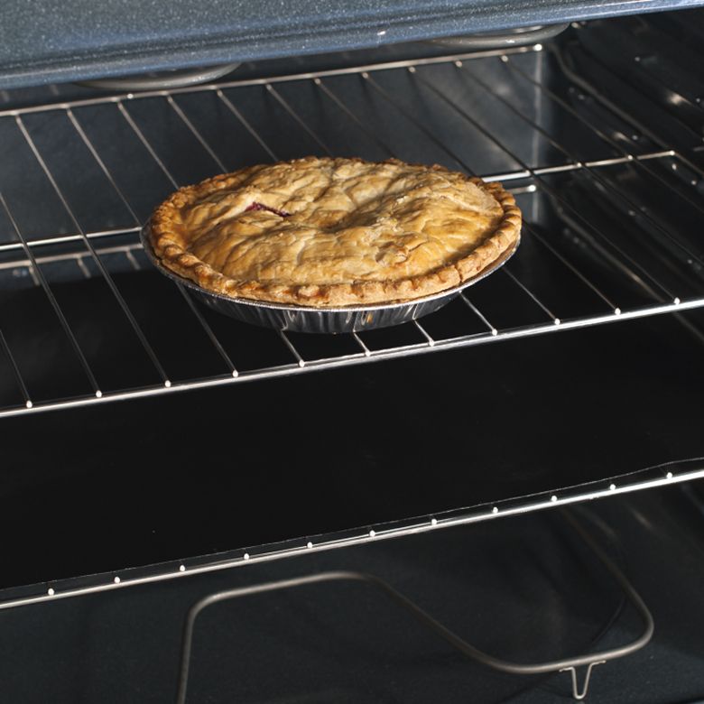 oven liner in oven with pie.
