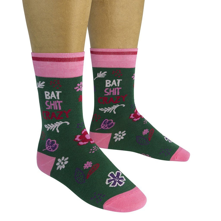 a person wearing the bat shit crazy socks on a white background