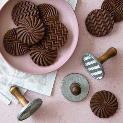 plate of chocolate cookies and cookie stamps.