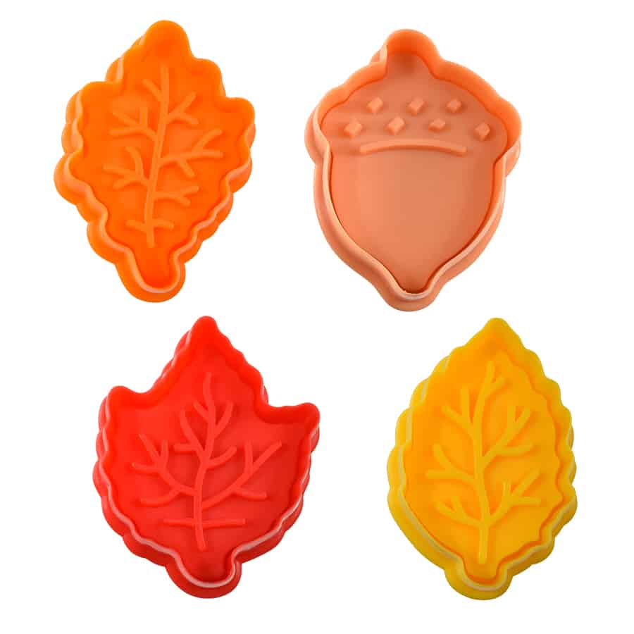 plastic stamps with shape and design of leaves and an acorn.
