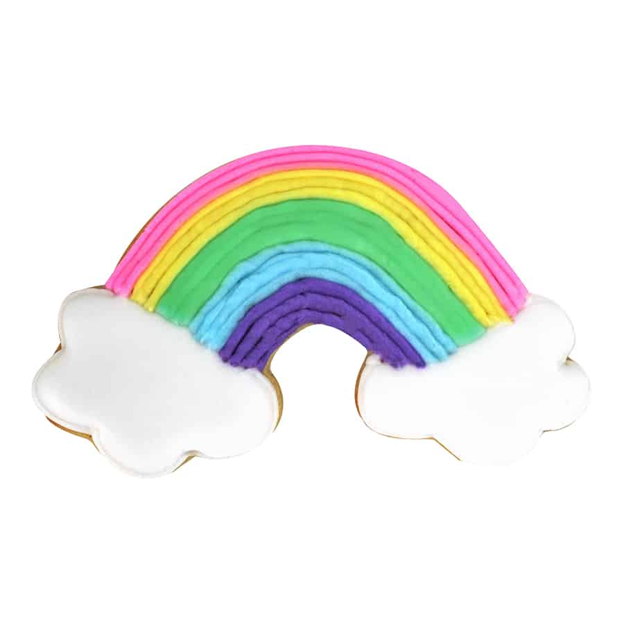rainbow with clouds on each end shaped cookie iced with pastel rainbow color icing and white icing on clouds.