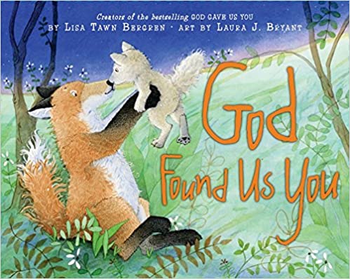 front of book has a parent fox holding baby fox while sitting in a field of grass, title, authors name, and illustrators name