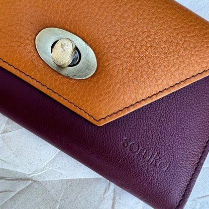 close up view of the maroon and mango secret clutch 