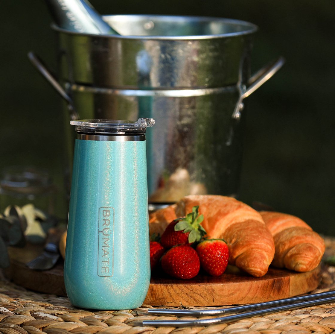 insulated champagne flute displayed with food a ice bucket on a placemat outside
