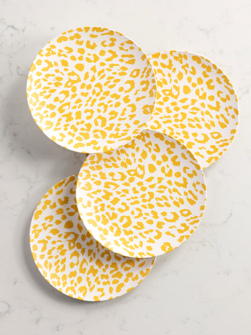 4 dinner plate with yellow cheetah print arranged on a marble background.