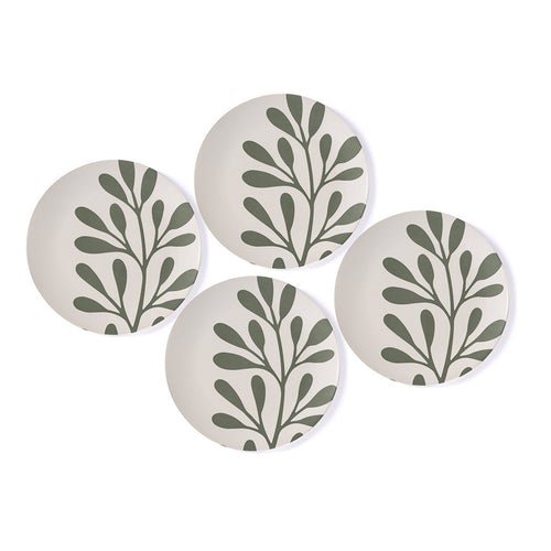 four bamboo melamine dinner plates on white background. plates are off-white with muted green leaf and branch design.