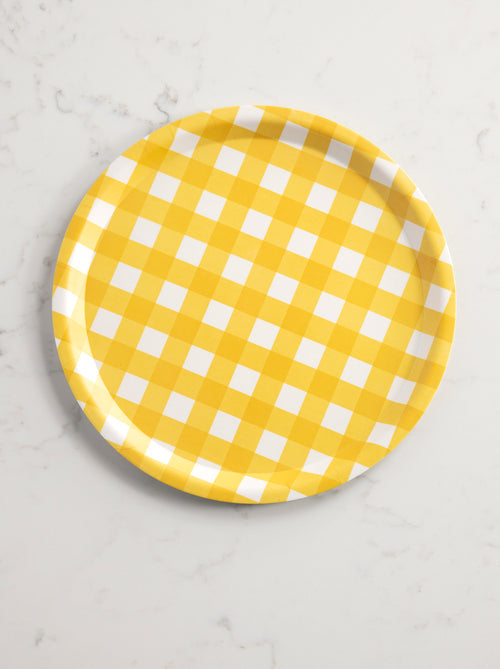 top view of tray with yellow and white check pattern on a marble background.
