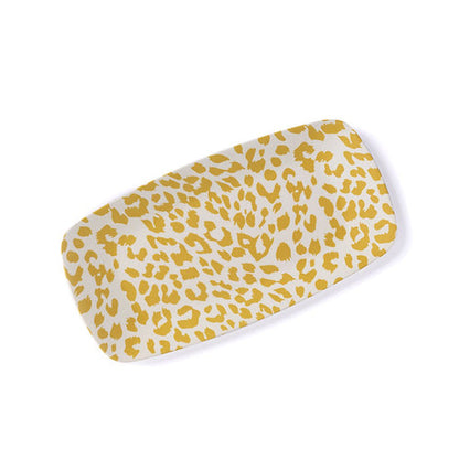 rectangular bamboo melamine tray set at an angle on white background. the tray is off-white whit a yellow cheetah print design.