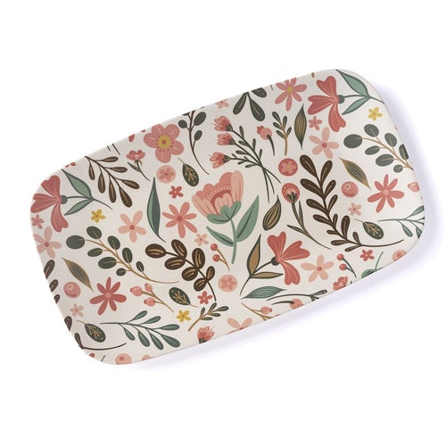 bamboo melamine tray set at an angle on white background. tray has an off-white background with an all-over pattern of flowers and leaves in muted tones of pinks, greens, browns, and yellows.