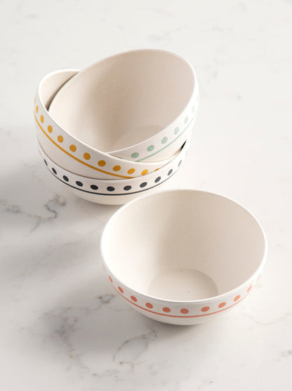 4 bowls with dotted rims arranged on a marble background.