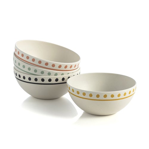 bamboo melamine bowls with dotted rims, three stacked on one to the side on white background. The bowls are off-white and have yellow, pink, mint green, or black dots.
