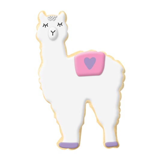 llama shaped cookie with white icing, pink saddle, closed eyes, and nose.