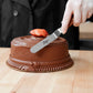 illustration of the small offset icing spatula being used to decorate a cake on a wooden surface