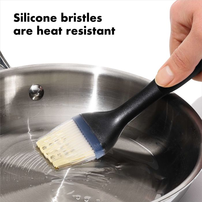 hand using brush to coat pan with oil and text "silicone bristles are heat resistant".