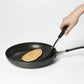 hand holding turner lifting pancake out of pan.