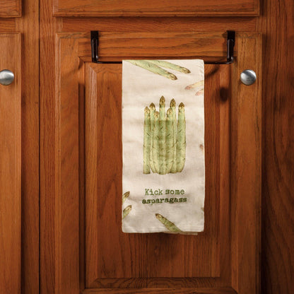 ivory towel with asparagus design hanging on bar on kitchen cabinets.