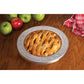 the 10 inch pie crust shield displayed with a baked pie next to apples on a light wood surface