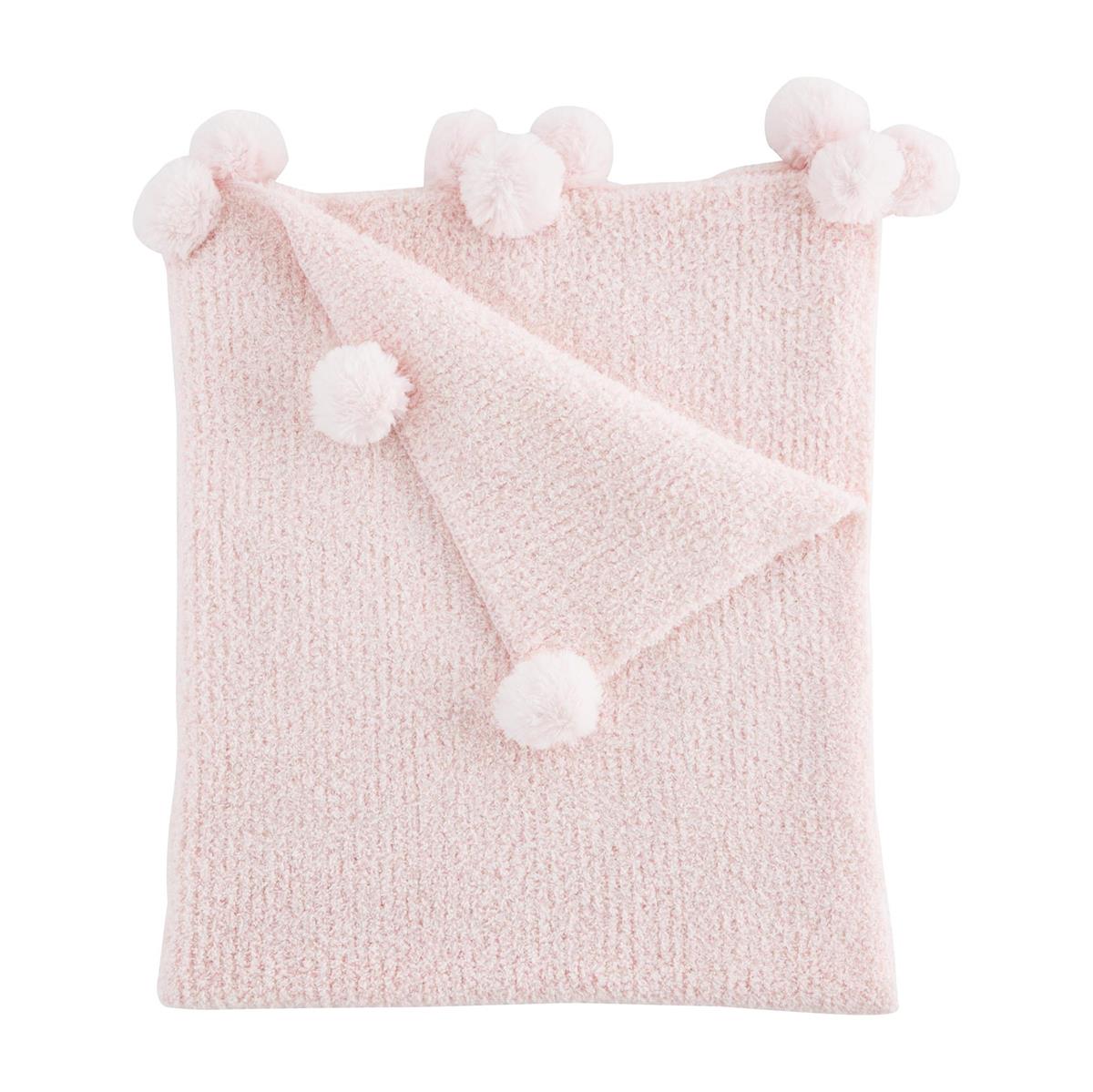 folded pink chenille blanket with pom poms on a white background