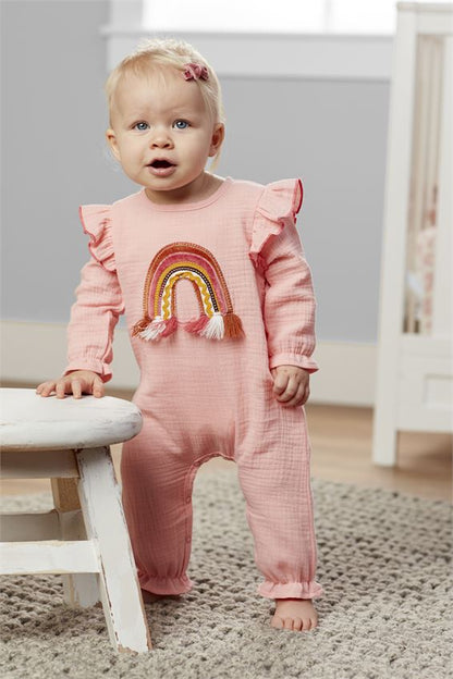 child wear pink rainbow outfit.