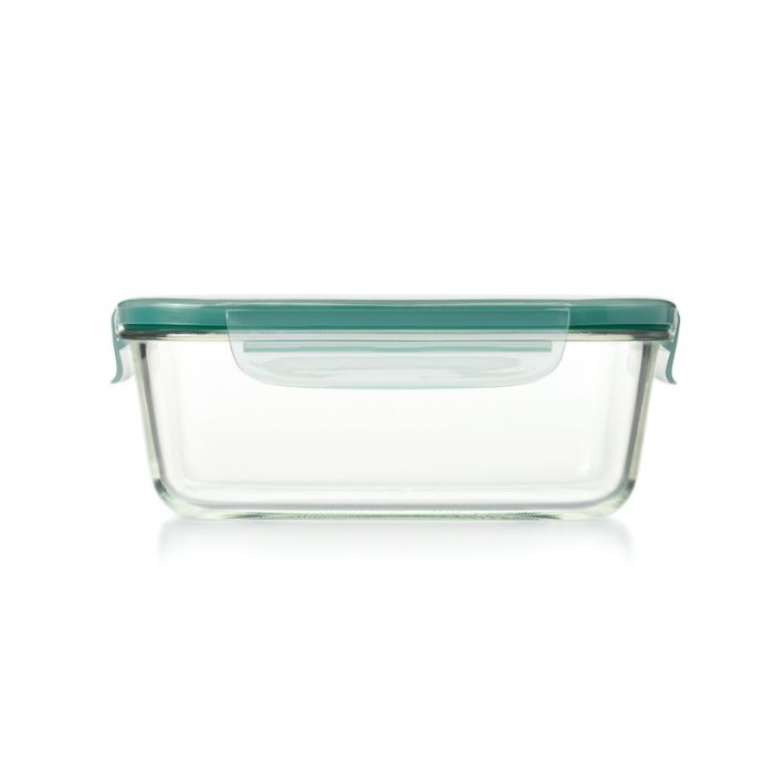 glass container with light green lid locked onto it.