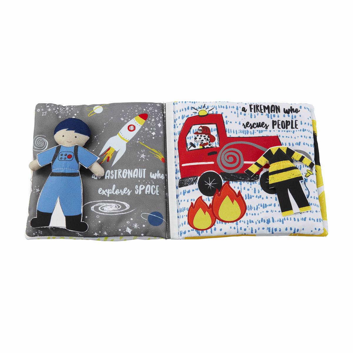 open book showing text and graphics of an astronaut and a fire fighter with the doll in astronaut clothing.