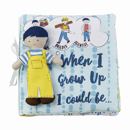 cover of blue soft book with a doll wearing yellow overalls attached and text "when i grow up i could be..." printed on it.
