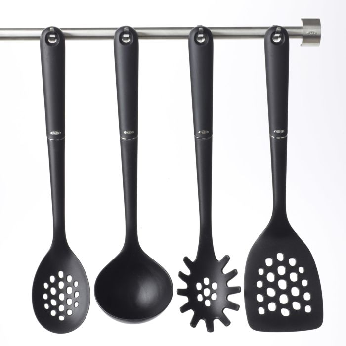 assorted black nylon utensils hanging on utensil bar.