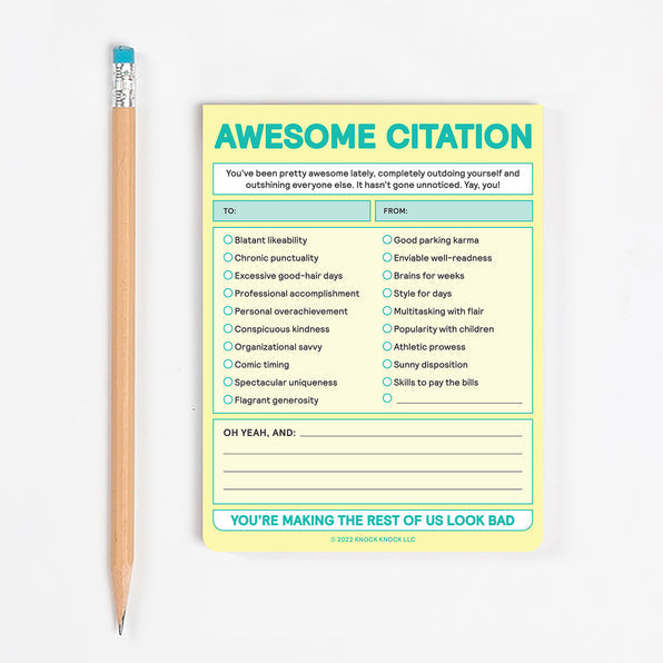 awesome citation nifty note pad and pencil on a white background