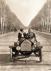 front of card is a photograph of a couple in an old timey convertible car