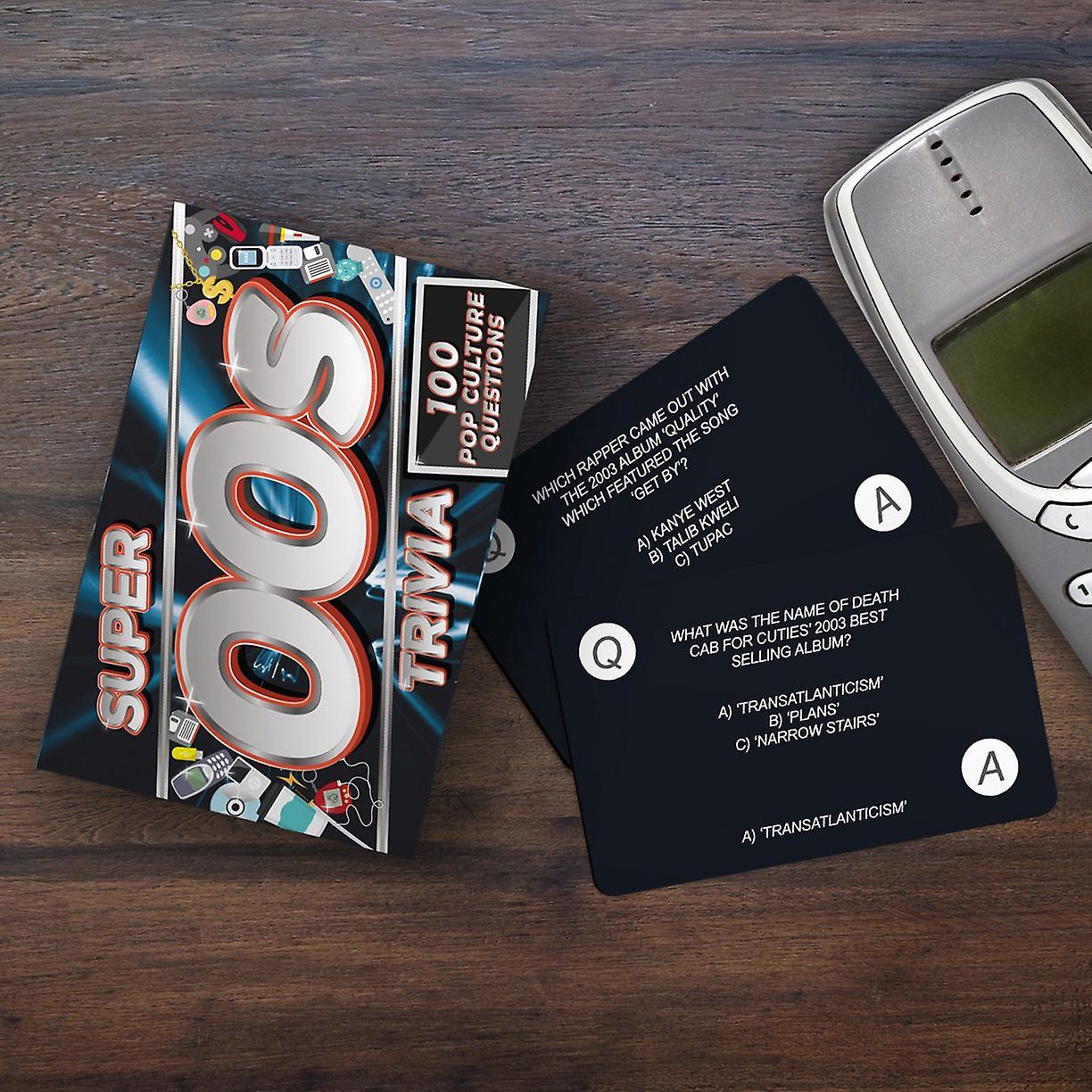 the super 00s trivia displayed with trivia cards beside a phone on a dark stained table 