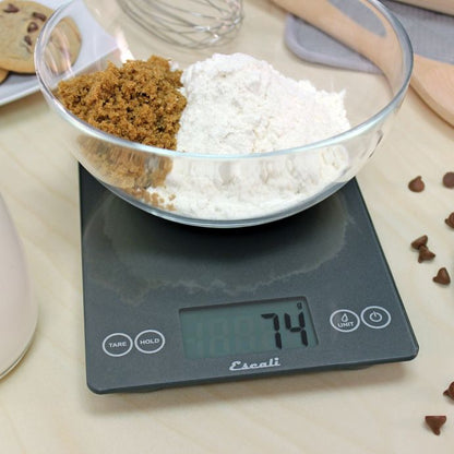 the arti glass digital scale displayed on a countertop being used with a bowl of flower 