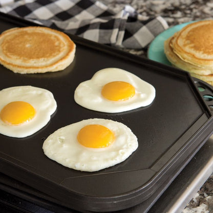 eggs and pancakes on smooth griddle.