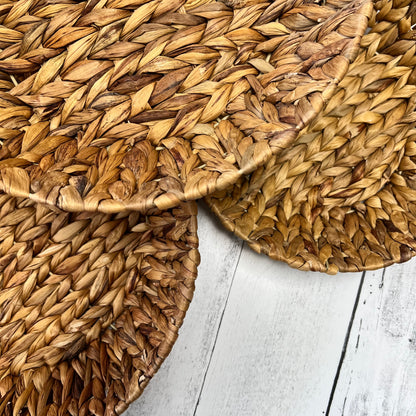 close-up  of 3 sizes of hyacinth baskets on a white wooden background.