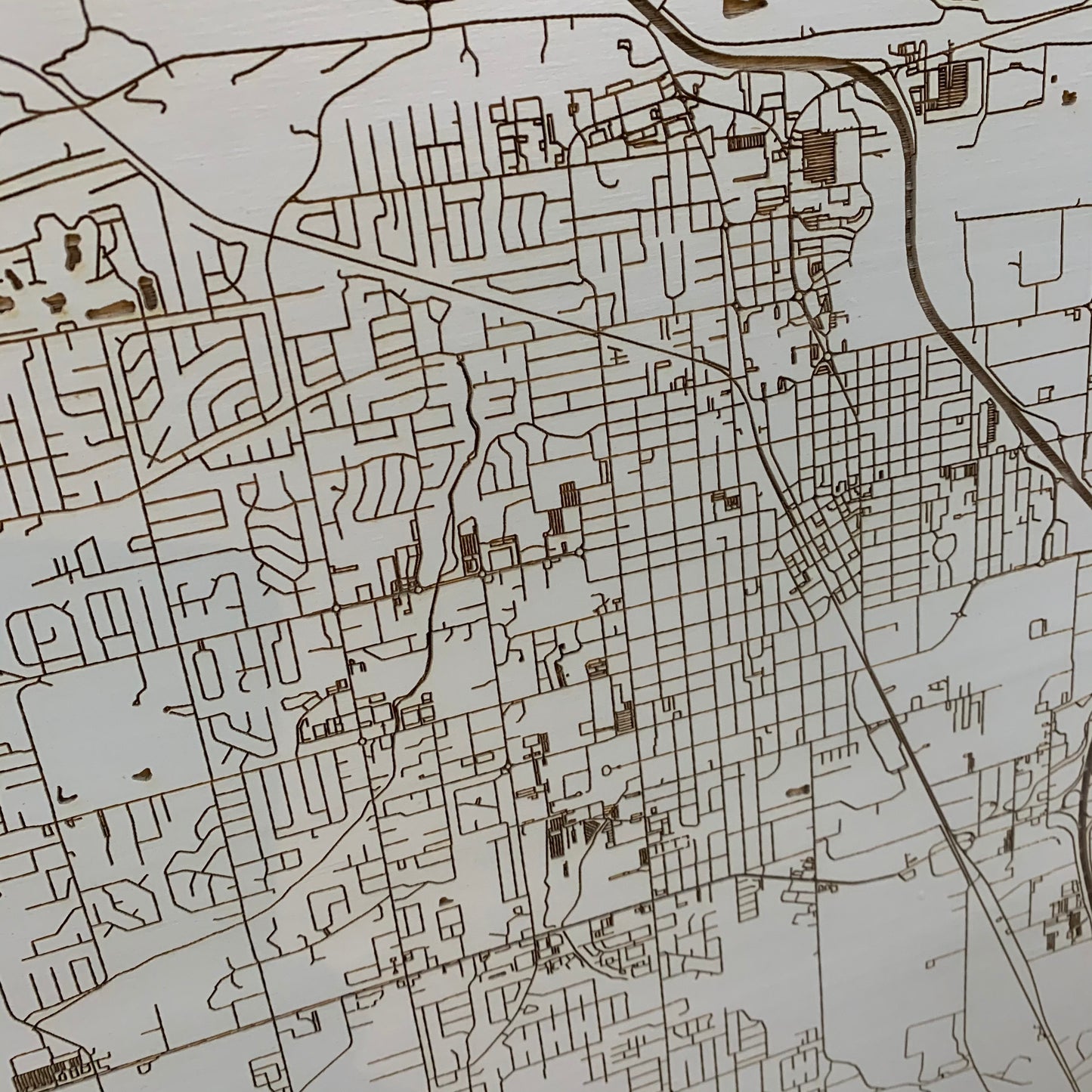 close up view of the burnt wood map of conway in grey