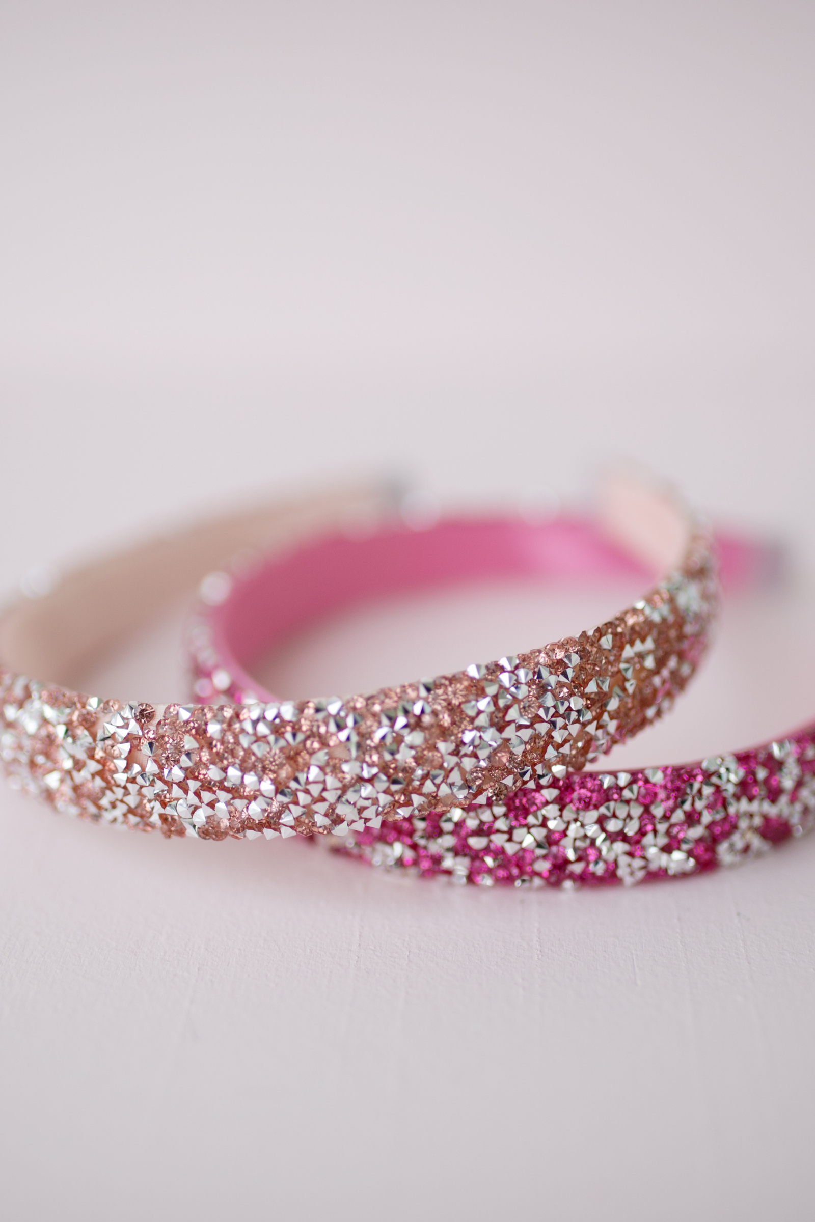 two gummy glitter boutique headband on a pale pink background