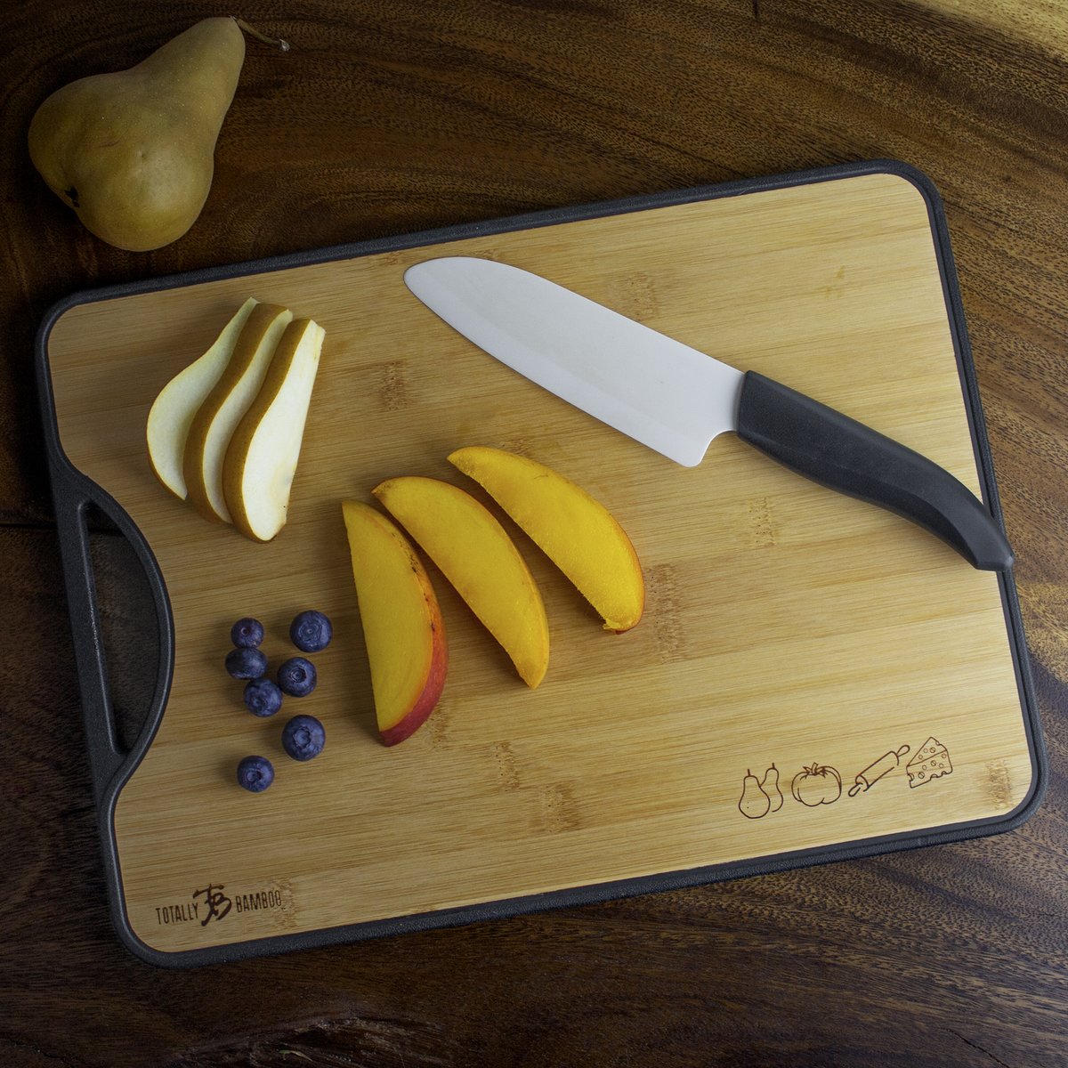 cutting board with knife, and fruit on it.