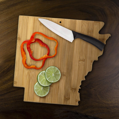 Arkansas shaped board with peppers and limes on it.