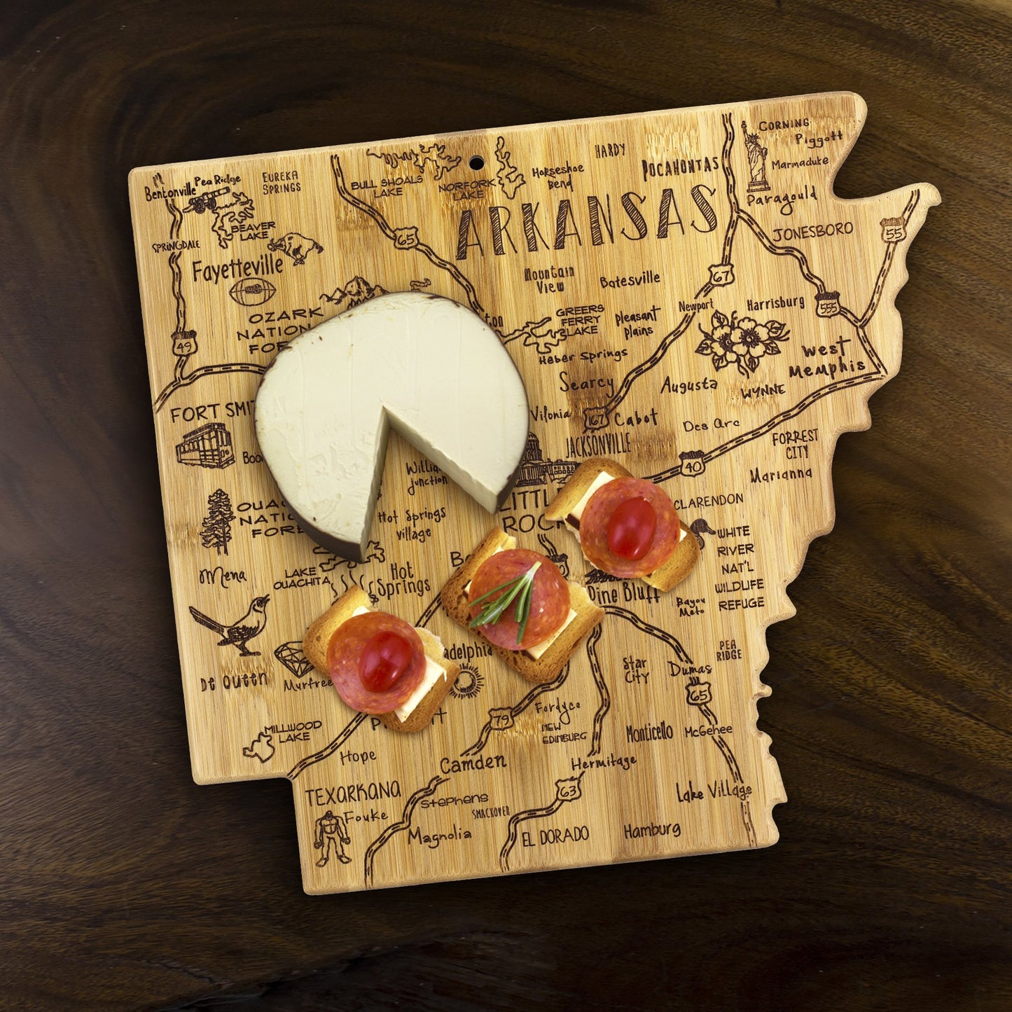 Arkansas shaped board with cheese and appetizers on it.