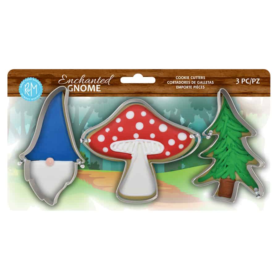 3 cookie cutters: gnome head, mushroom, and tree, on cardboard packaging showing decorating ideas.