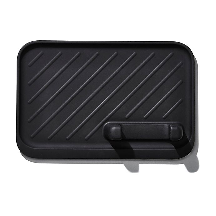 rectangular black silicone utensil rest with slot for placing tongs.