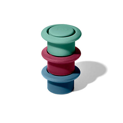 green, red, and blue silicone stoppers stacked up.