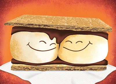 two marshmallows with smiling faces in a s'mores sandwich 